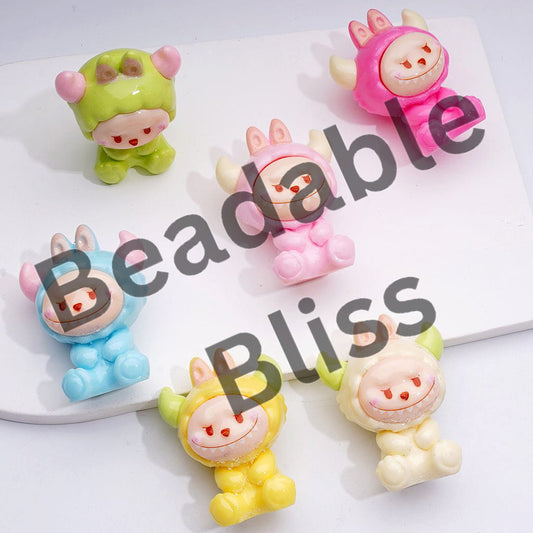 Colorful animal figurines on a white surface with 'handsontupply.com' text.