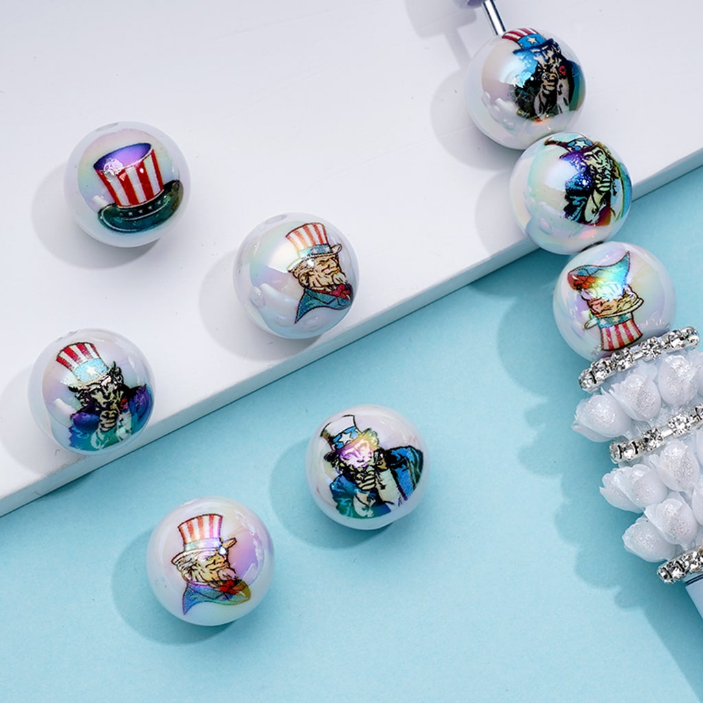 Decorative beads with cartoon characters on a light blue surface

