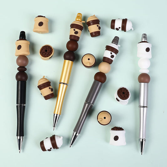 Set of pens with unique pen toppers resembling coffee cups on a light blue background