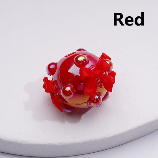 Red glass figurine on a white base with 'Red' text above.

