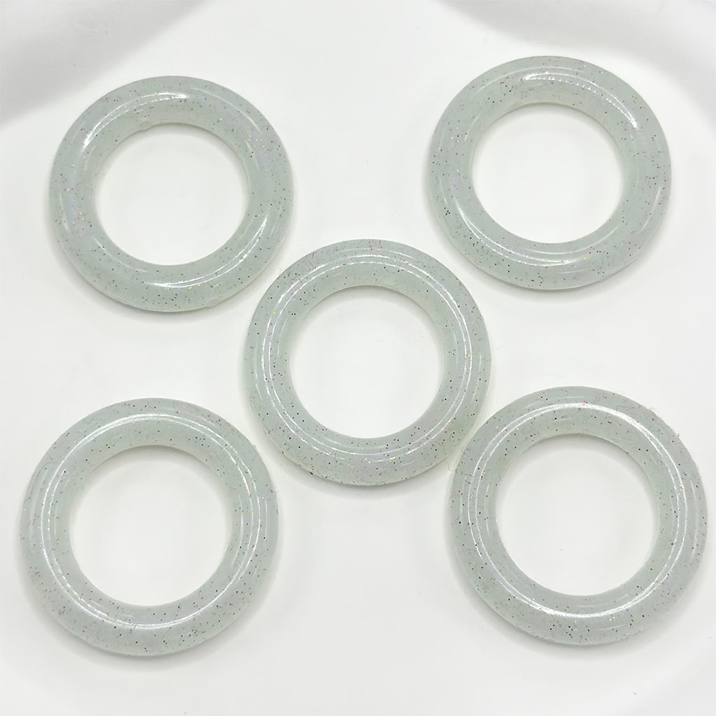 Five metallic washers on a white background

