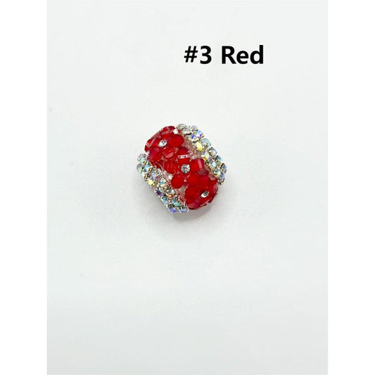 A collection of multicolored round acrylic beads designed for keychains, displayed alongside a pink pen for scale.

