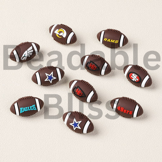 Collection of sports-themed pens and ballpoint pens on a light background

