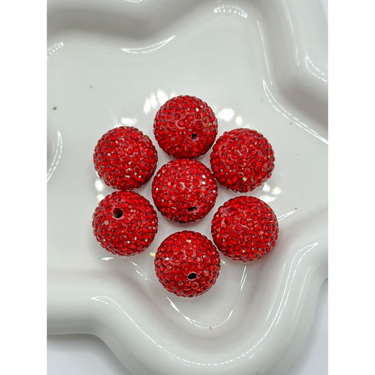 Red beaded balls on a white textured surface