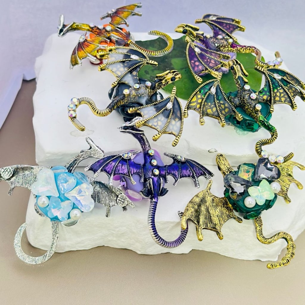 A collection of alloy dragon figurines in various colors, adorned with colorful mini AB rhinestones, white pearls, and other decorative elements.

