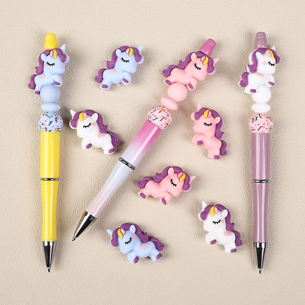 Unicorn-shaped pens and erasers on a beige background

