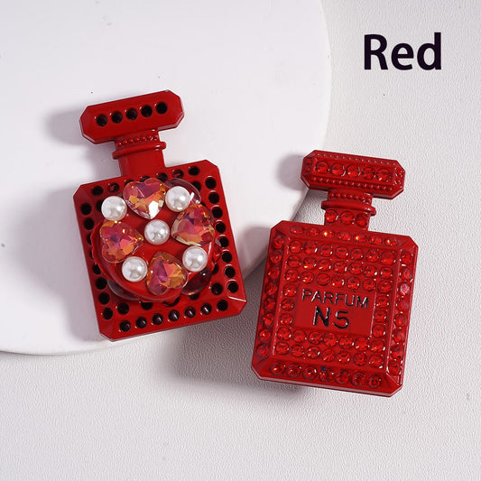 A collection of alloy bling bling parfum perfume bottles in various colors, each adorned with colorful shiny rhinestones, white pearls, and colorful hearts clay beads.

