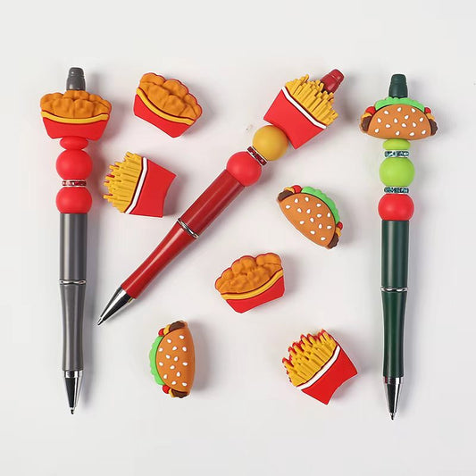 Colorful pens with food-themed designs on a white background


