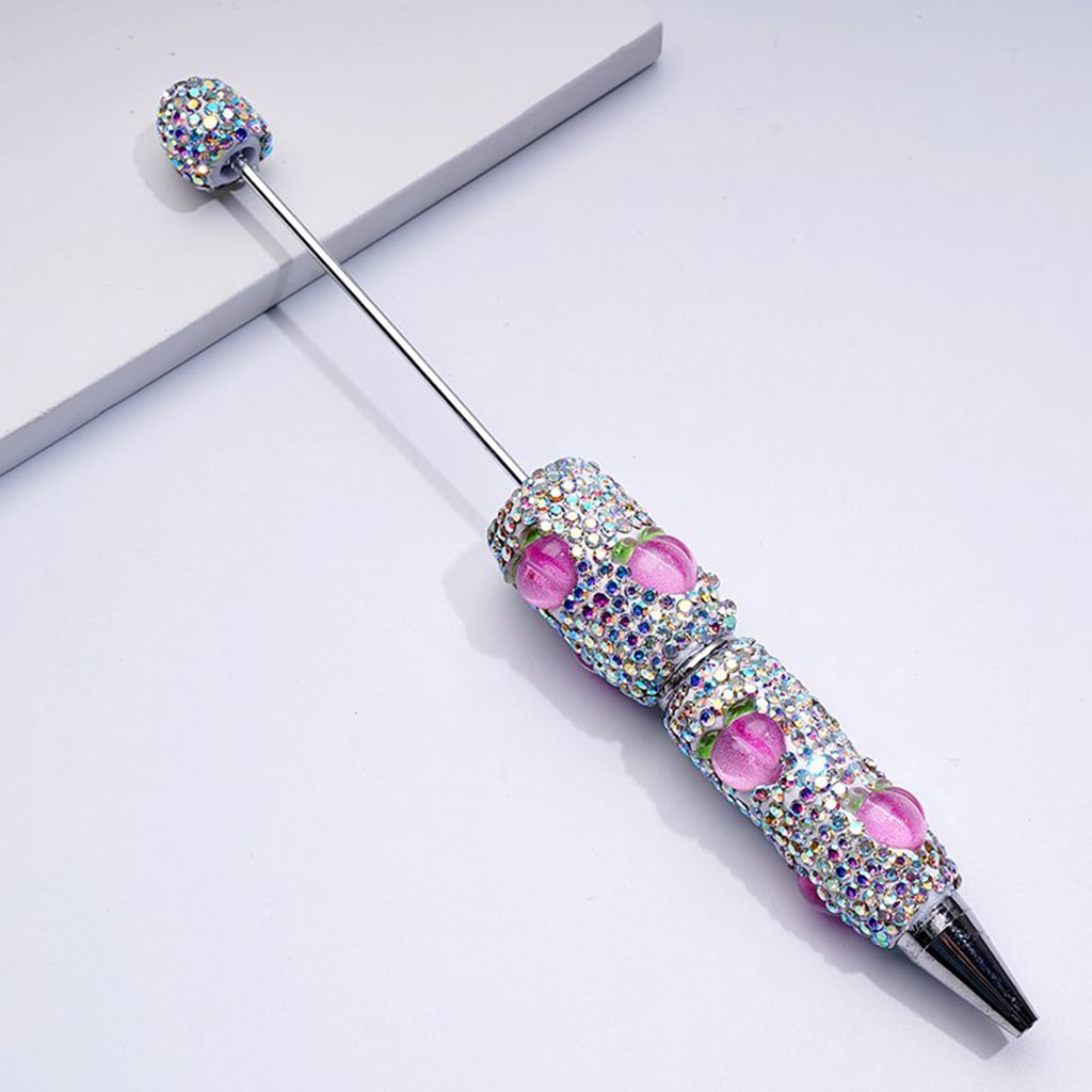 Decorative pen with gemstones on a white background