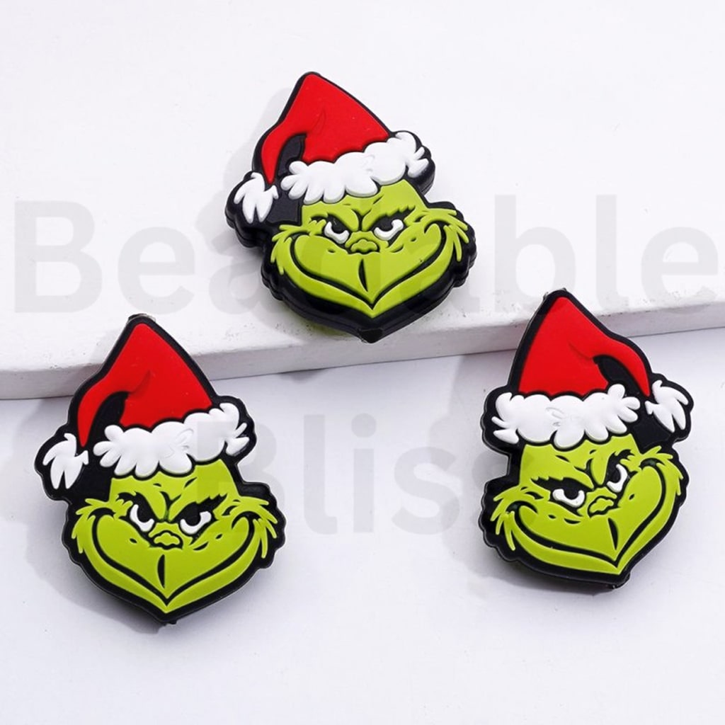 赤いクリスマス帽子のシリコーン焦点ビーズと漫画の緑のモンスター