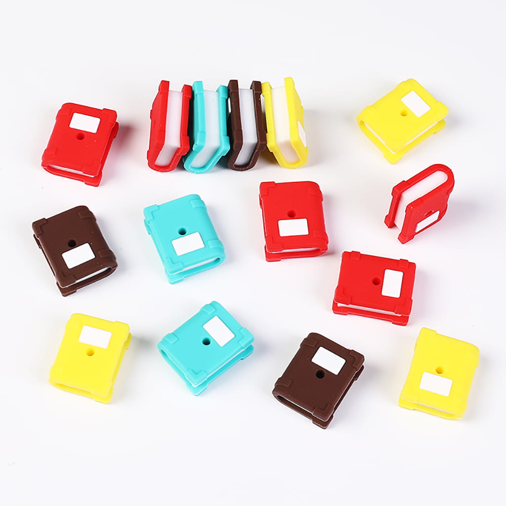 Colorful plastic clips arranged on a white background