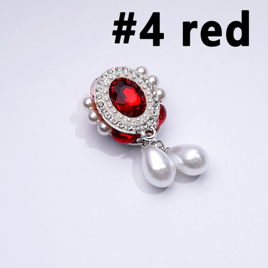 A collection of silver alloy pins with oval shapes featuring a large red rhinestone in the center, surrounded by mini clear rhinestones and white pearls, displayed against a white background.

