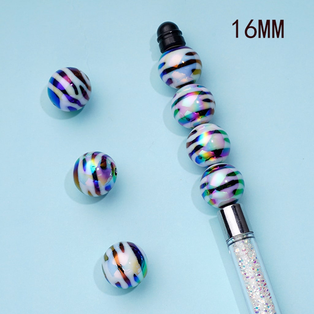 Decorative pen with multicolored beads on a light blue background

