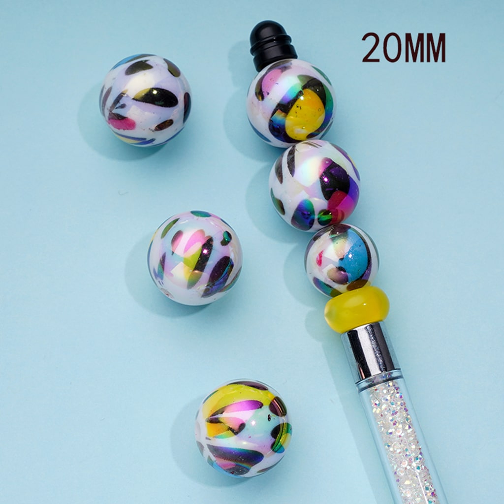 Colorful beaded pen with multicolored beads on a light blue background

