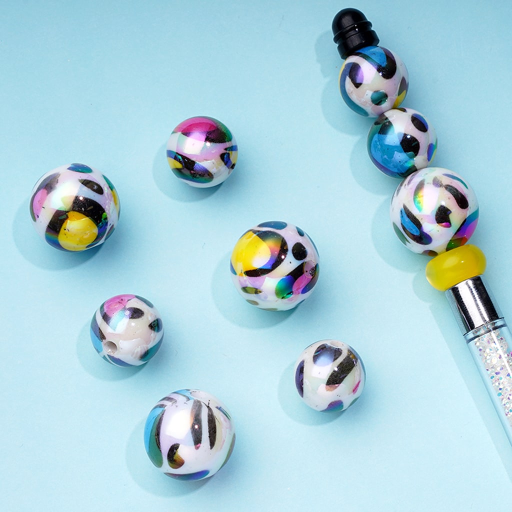Colorful beaded pen on a light blue background

