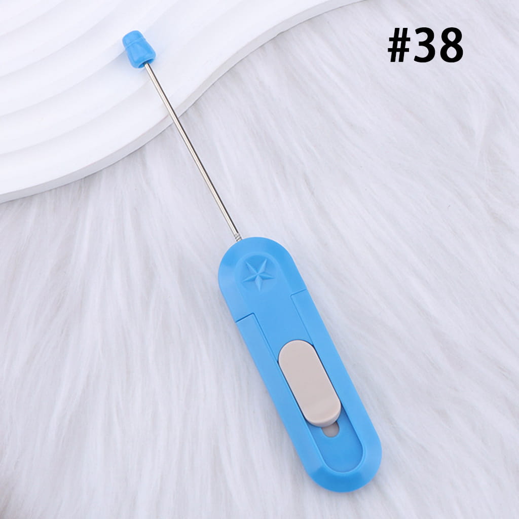 Blue seam ripper on a white fabric background