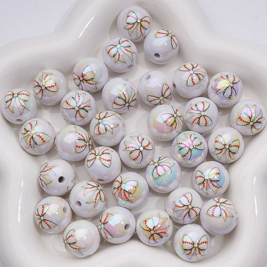 White pearls with brown bow decorations on a white surface


