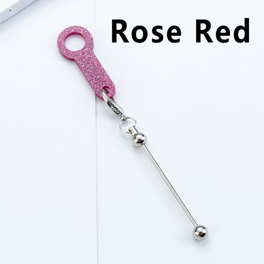 Rose red keychain with a long metal bar on a white background

