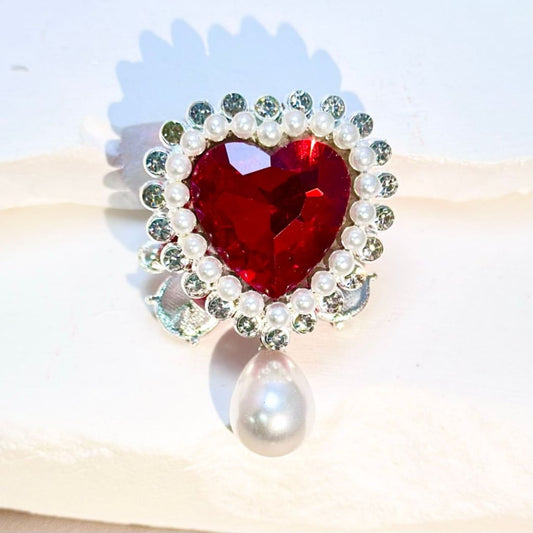 A selection of silver alloy jewelry findings featuring heart and butterfly shapes, adorned with clear rhinestones, white pearls, and large heart-shaped diamonds.

