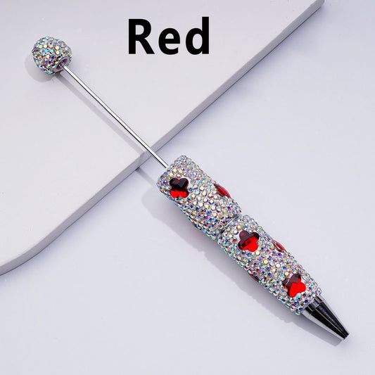 A collection of multicolored beadable clay pens with shiny four-leaf clover-shaped rhinestones covering the entire pen.

