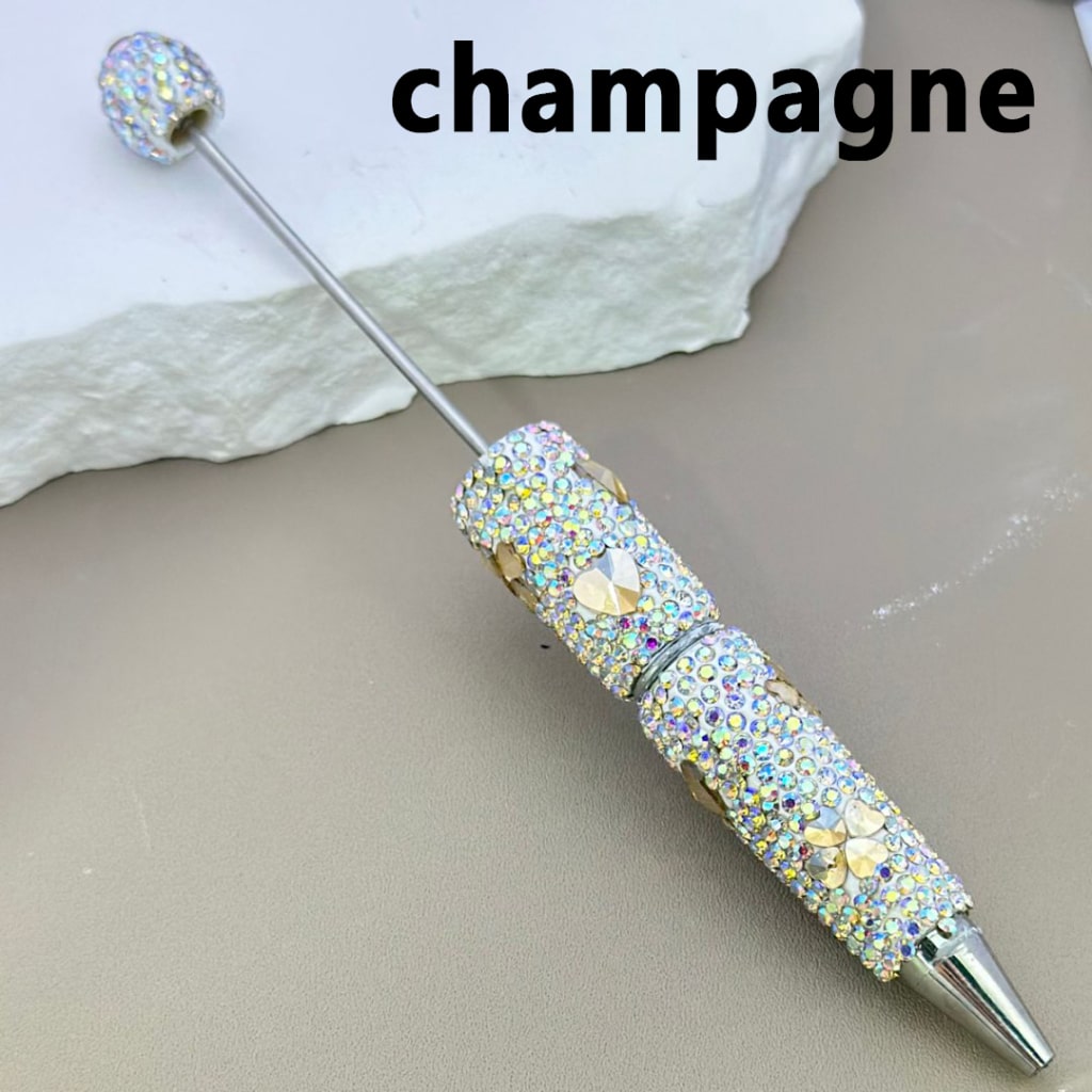 Decorative champagne swizzle stick with crystals on a neutral background