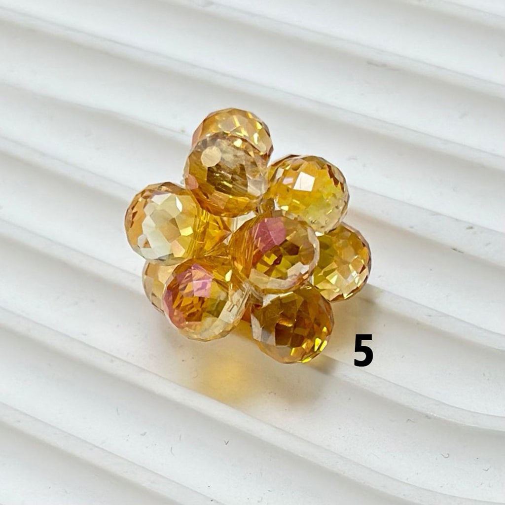 Multicolored gemstone flower on a white textured background

