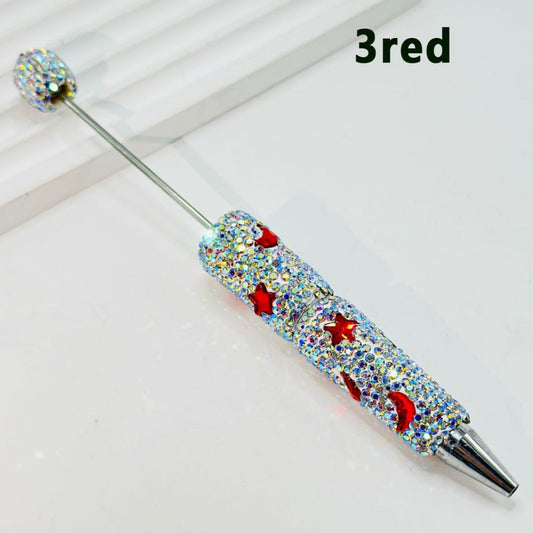 A collection of pens with beadable clay covered in rhinestones, featuring various colors including clear, silver, and multicolored designs with star and moon motifs.

