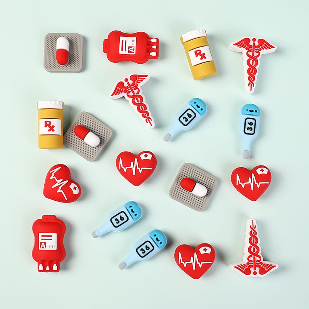 Collection of medical-themed decorative items including bottles, hearts, and thermometers on a light blue background.