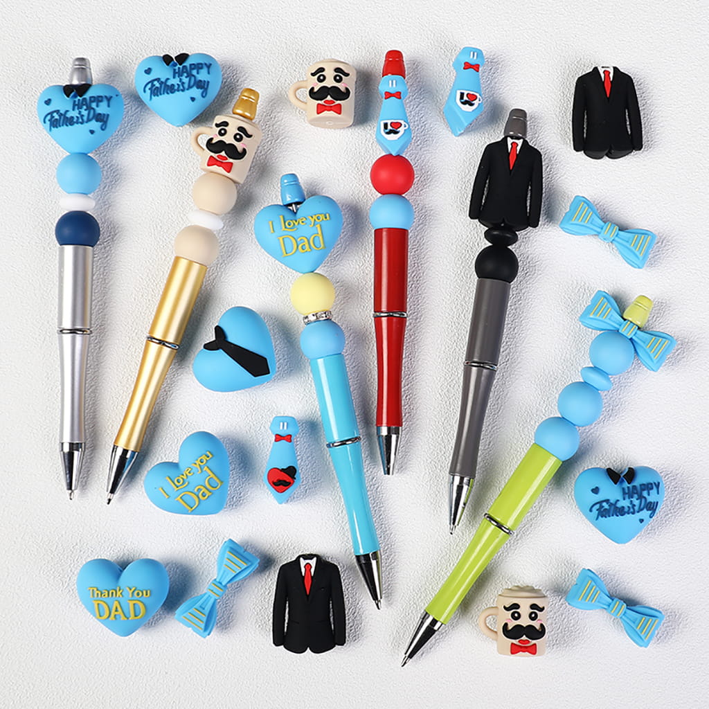 Collection of pens and decorative items with Father's Day-themed designs on a white background