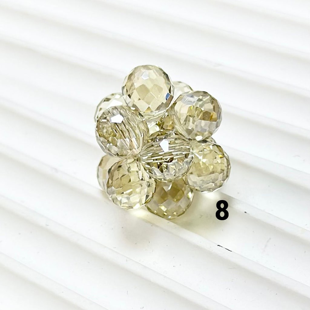 Clear crystal flower-shaped jewelry piece on a white background

