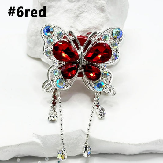 A collection of colorful butterfly-shaped alloy clay beads with rhinestones and pendant chains.

