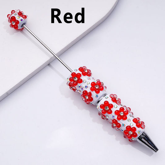Decorative pen with red flower designs on a white background

