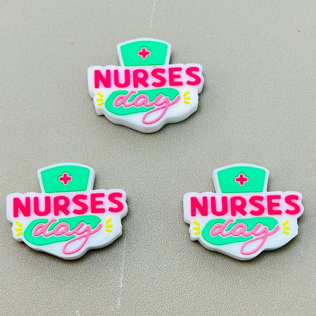 Silicone beads with 'Nurses Day' text and a nursing cap symbol in green and pink colors.

