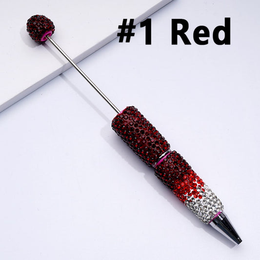 A collection of beadable clay pens with ombre color and shiny rhinestones covered over the entire pen. The pens are displayed in various colors including blue, purple, pink, red, black, and silver.

