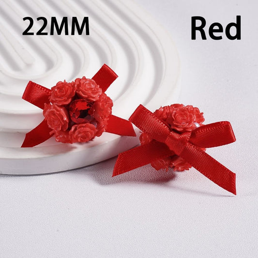 Two red flower-shaped objects with ribbons on a white background, labeled '22MM' and 'Red'.