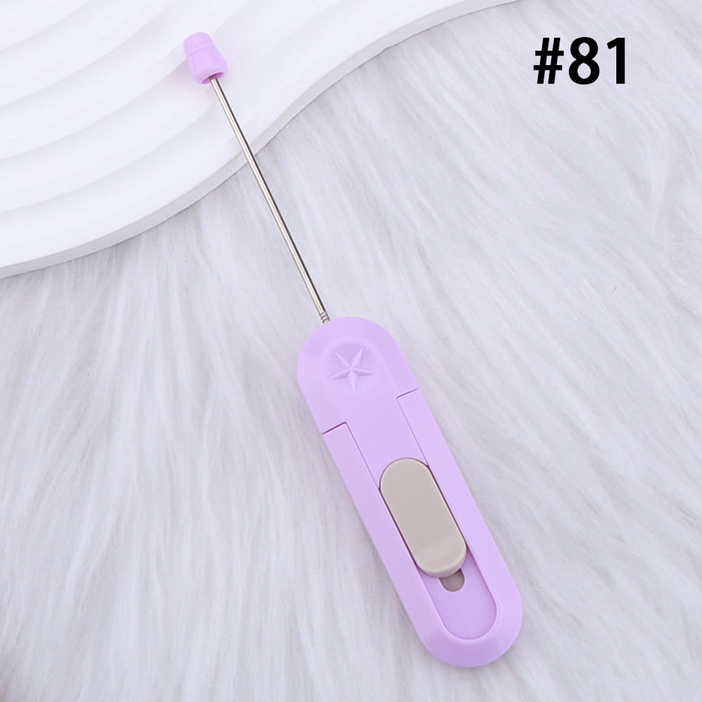 Purple and beige sewing needle threader on a white background