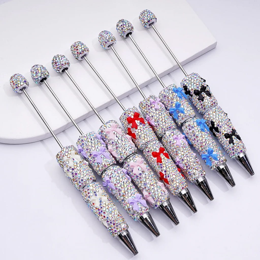 Set of decorative pens with gemstone accents on a white background