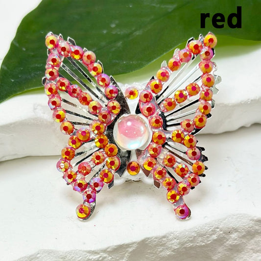 A collection of silver alloy butterfly-shaped beads with colorful mini rhinestones, white pearls, and colorful mini butterfly rhinestone clay beads.

