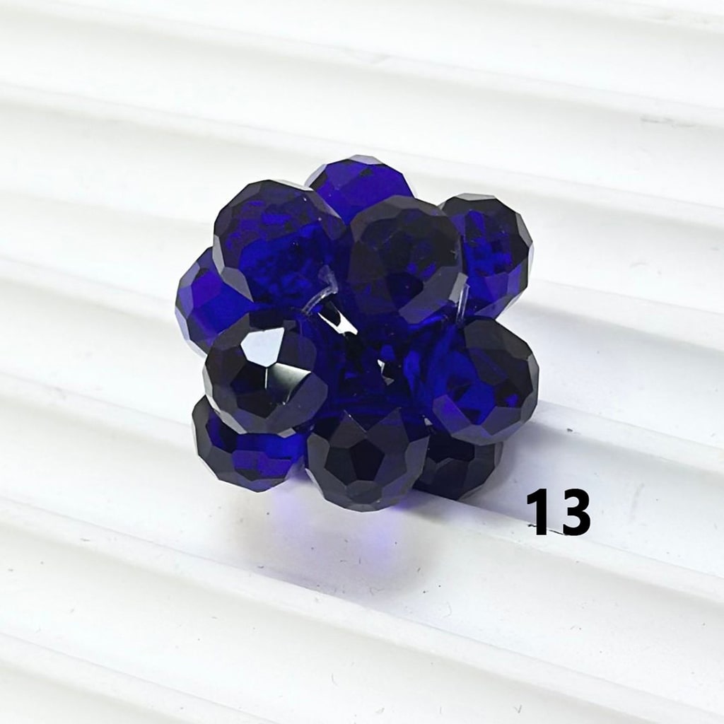 Blue faceted beads on a white background


