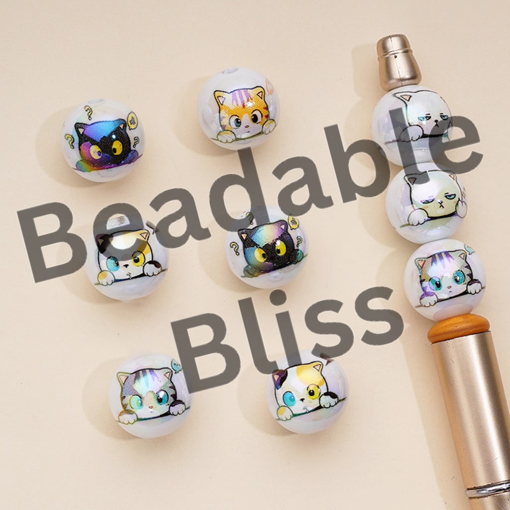 Beadable Bliss cat-themed beads on a beige background

