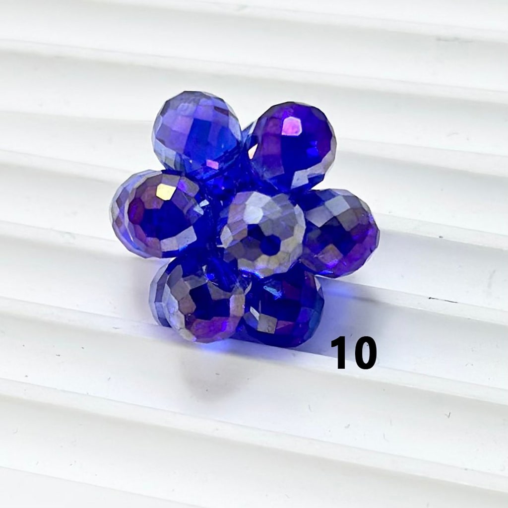 Purple flower-shaped decorative item on a white background

