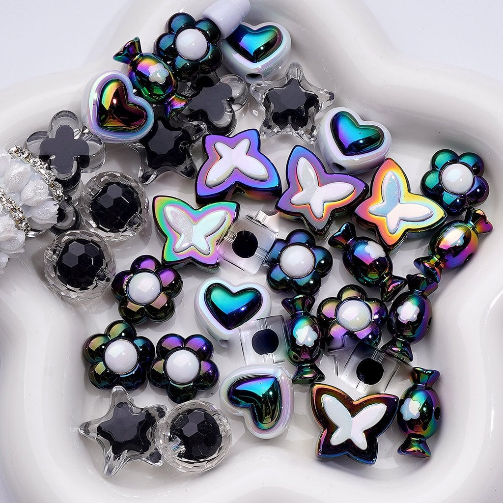 Assorted colorful jewelry charms on a white background

