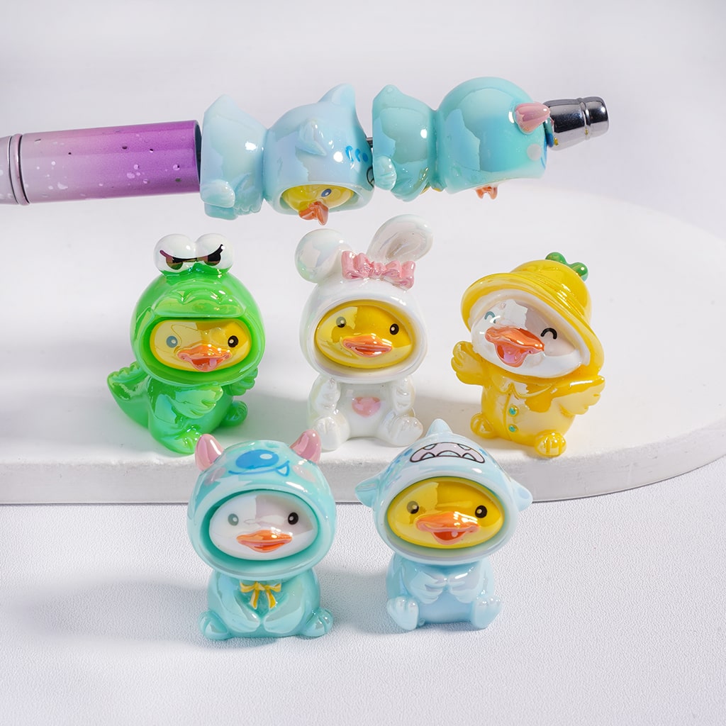 Set of colorful duck-shaped figurines in costumes on a white background