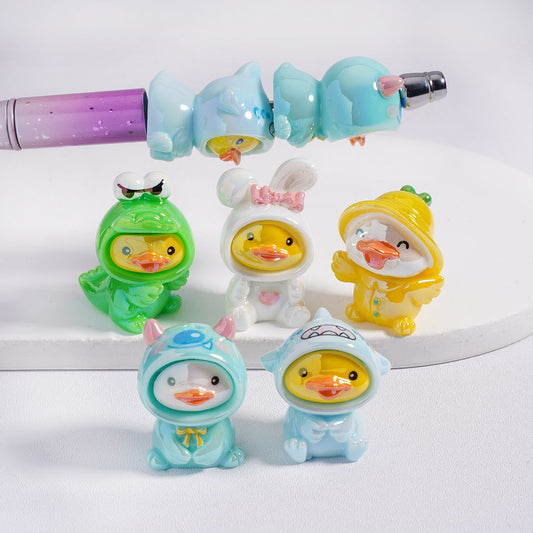Set of colorful duck-shaped figurines in costumes on a white background