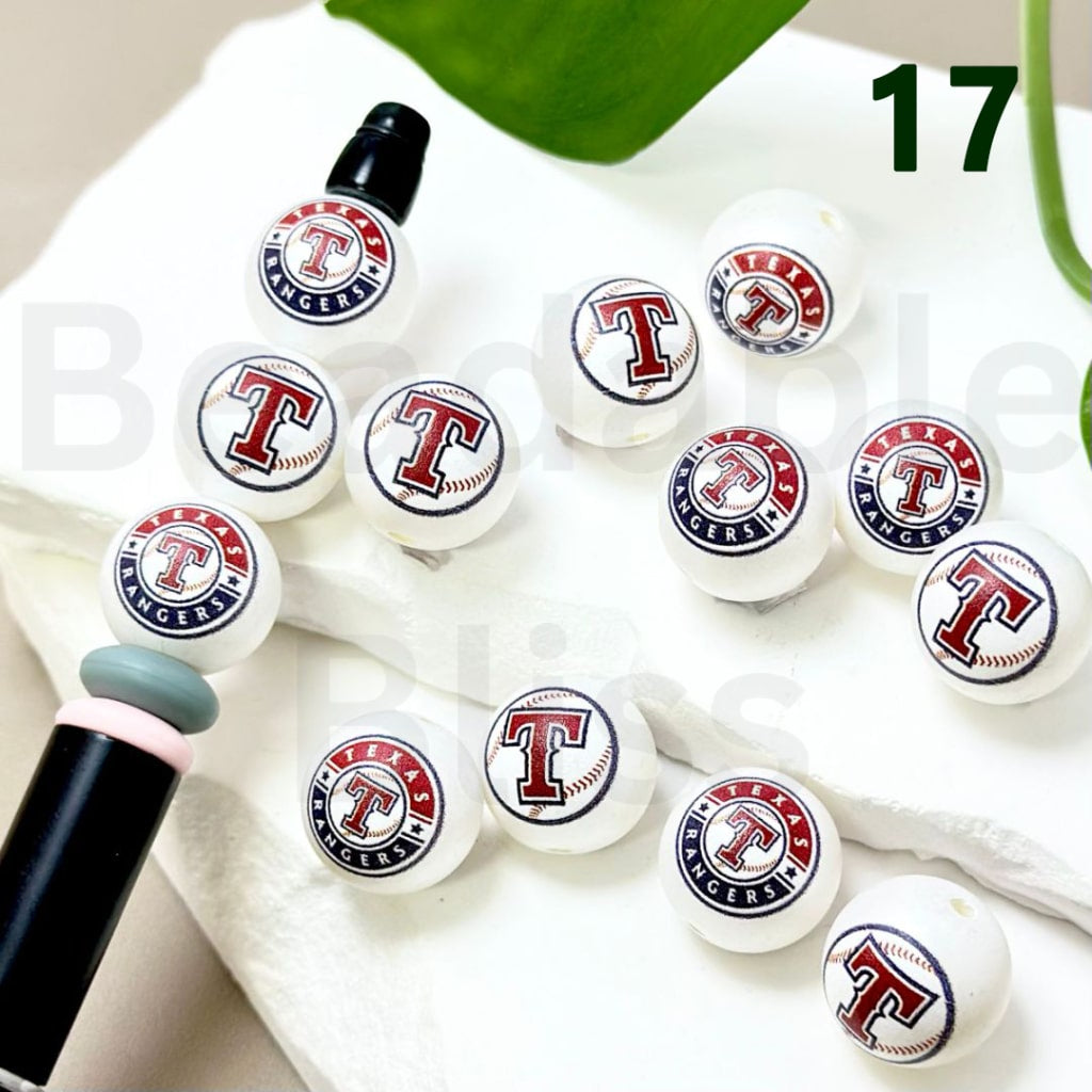 White earbud tips with Texas Rangers logo on a white surface

