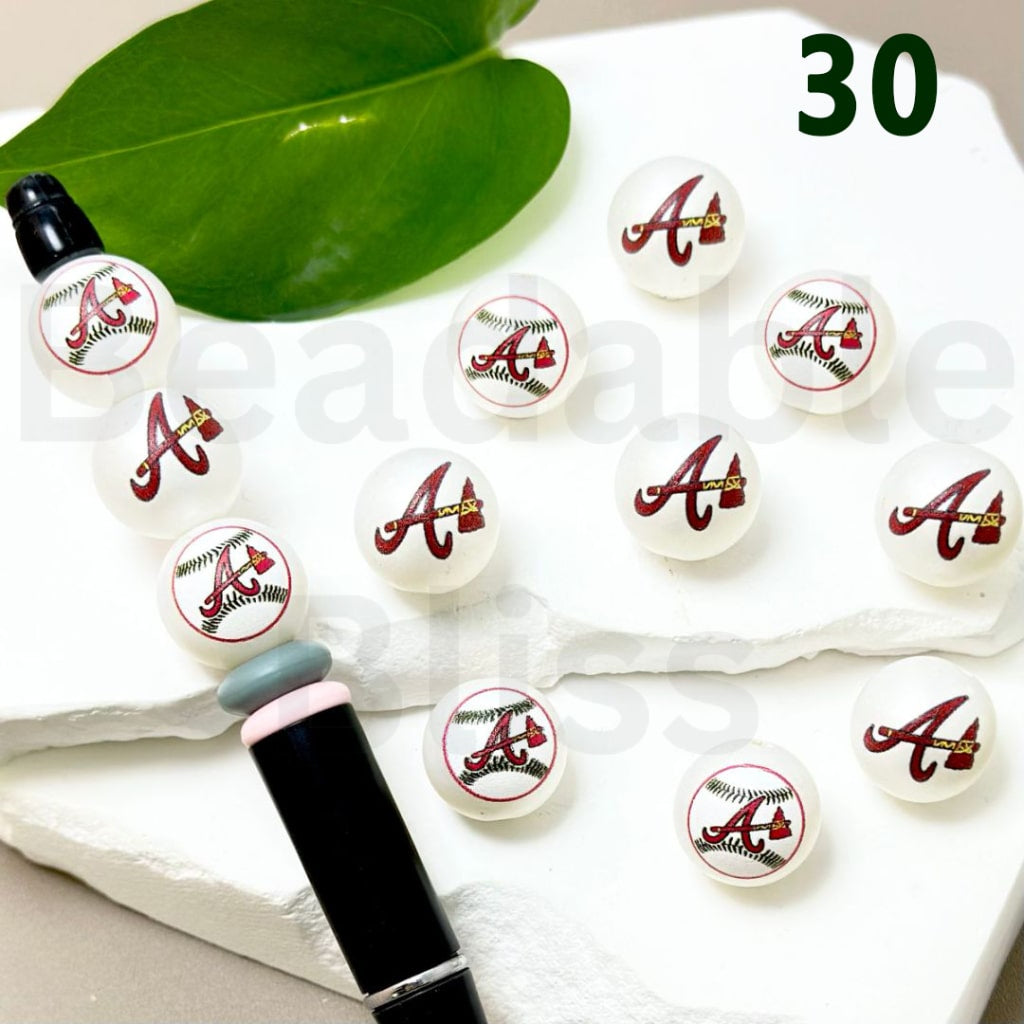 Set of decorative items with 'A' logo on a white surface with green leaves.

