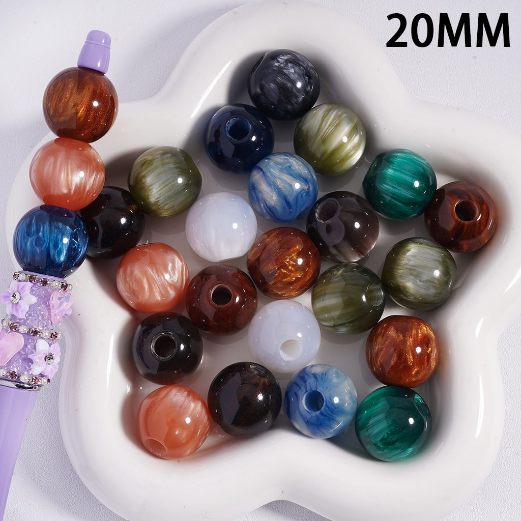 Assorted colored beads on a white dish with '20MM' text.