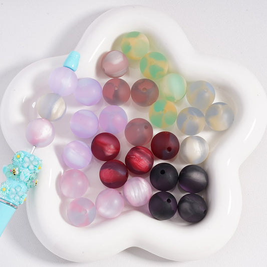 Colorful beads on a white heart-shaped dish

