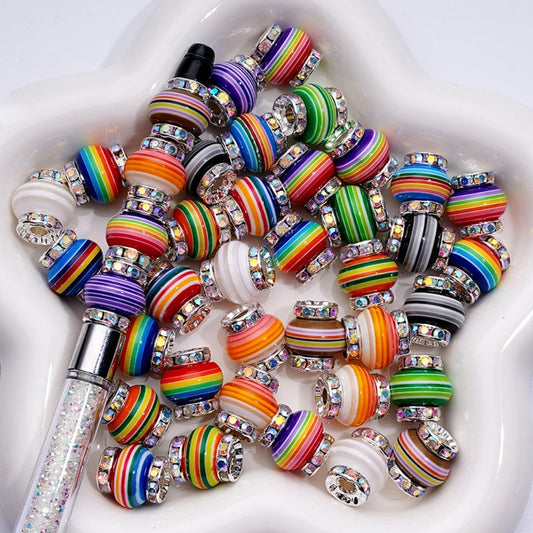 A collection of multicolored round acrylic beads with flat silver metal spacers and AB rhinestones

