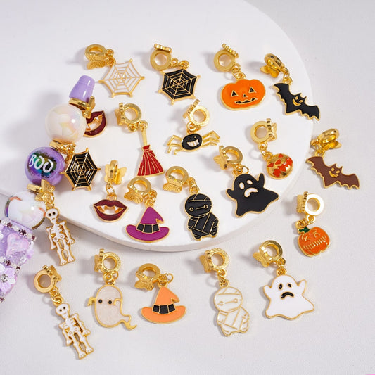 Collection of Halloween-themed charms on a white plate

